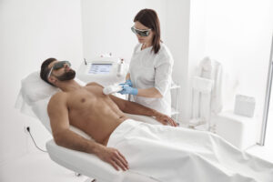 female-cosmetologist-does-laser-epilation-chest-athletic-man-using-modern-equipment-scaled.jpg